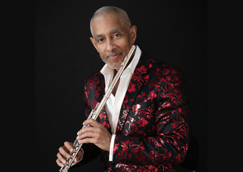 Man in a red jacket holding a flute