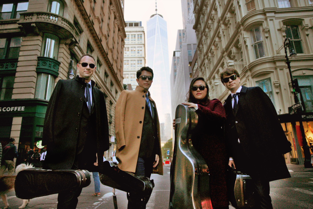 Calidore String Quartet members standing in New York City