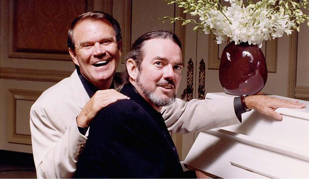 Glen Campbell and Jimmy Webb sitting at piano