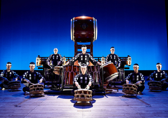 Group sitting on the floor drumming