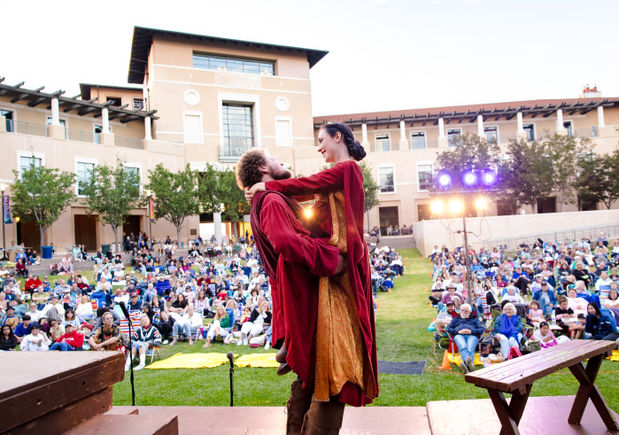 Actors hold eachother during a performance of Shakespeare by the Sea on SUA's Campus Green