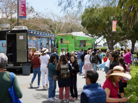 People wait outside food trucks during the festival