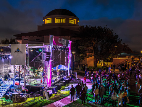 Ozomatli performs on a lit up stage at night on SUA's campus during the 2024 Soka Peace Festival